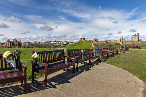 Memorial benches at Spanish Battery, Tynemouth in North Tyneside, with Tynemouth Priory in the distance.