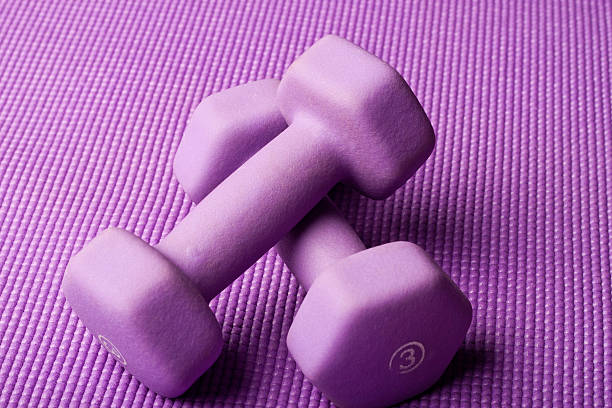 istock Purple weights on yoga mat 177620894