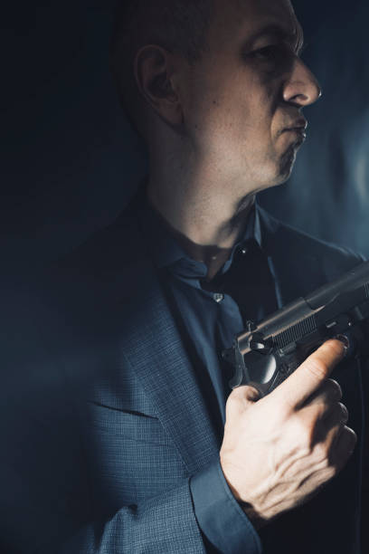 istock Mercenary hitman spy assasin with gun 1776222035