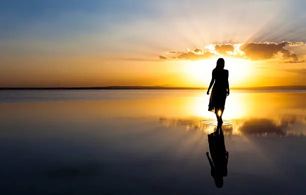 Beautiful woman walking on a gorgeous lake