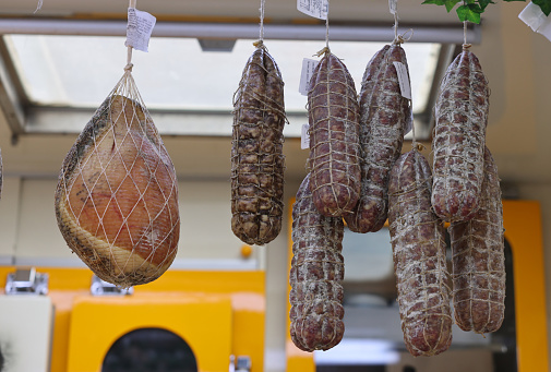 Cremona, Italy - September 7, 2022: Traditional meat products sold at a street stall during the farmers market in Cremona, Lombardy, Italy