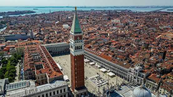 Venice (Italian: Venezia) is a city in northeastern Italy and the capital of the Veneto region. It is built on a group of 118 small islands that are separated by expanses of open water and by canals; portions of the city are linked by over 400 bridges. The islands are in the shallow Venetian Lagoon, an enclosed bay lying between the mouths of the Po and the Piave rivers (more exactly between the Brenta and the Sile).\n\nPiazza San Marco, often known in English as St Mark's Square, is the principal public square of Venice, Italy, where it is generally known just as la Piazza (\