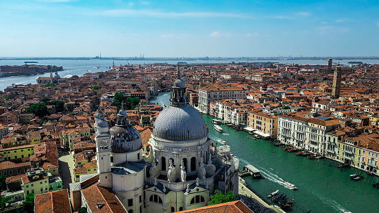 Venice (Italian: Venezia) is a city in northeastern Italy and the capital of the Veneto region. It is built on a group of 118 small islands that are separated by expanses of open water and by canals; portions of the city are linked by over 400 bridges. The islands are in the shallow Venetian Lagoon, an enclosed bay lying between the mouths of the Po and the Piave rivers (more exactly between the Brenta and the Sile).\n\nSanta Maria della Salute (English: Saint Mary of Health), commonly known simply as the Salute, is a Roman Catholic church and minor basilica located at Punta della Dogana in the Dorsoduro sestiere of the city of Venice, Italy.