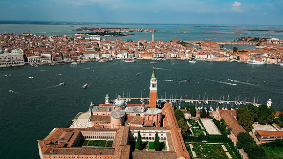 Venice (Italian: Venezia) is a city in northeastern Italy and the capital of the Veneto region. It is built on a group of 118 small islands that are separated by expanses of open water and by canals; portions of the city are linked by over 400 bridges. The islands are in the shallow Venetian Lagoon, an enclosed bay lying between the mouths of the Po and the Piave rivers (more exactly between the Brenta and the Sile).\n\nSan Giorgio Maggiore (Venetian: San Zorzi Mazor) is one of the islands of Venice, northern Italy, lying east of the Giudecca and south of the main island group. The island, or more specifically its Palladian church, is an important landmark. It has been much painted, featuring for example in a series by Monet.