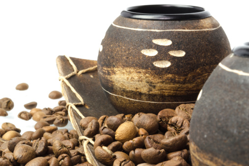 coffee beans, wooden cup and plate on white background