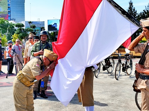 “Semarang, Indonesia – August 17, 2023 : The antique bicycle community held a Flag Ceremony during the commemoration of the independence day of the Republic of Indonesia in the Tugu Muda monument area, Semarang, Indonesia\