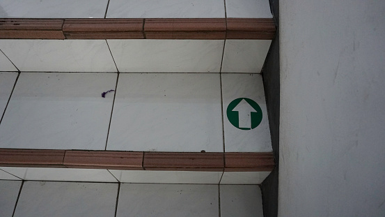 Stairs with up signs with arrows indicating how to use the road. Direction sign up on stairs