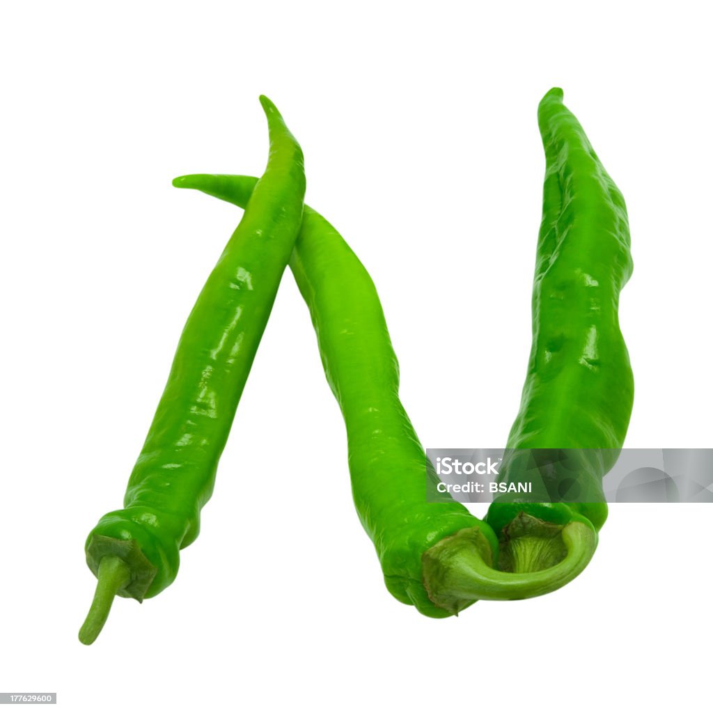 Letter N composed of chili peppers Letter N composed of green peppers. Isolated on white background Cayenne Pepper Stock Photo