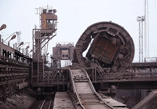 Rail-car dumper offloading iron ore at the steel mill