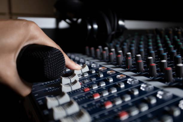 istock Men's hands are controlling the console of a large hi-fi system. Sound equipment. Control panel of a digital studio close-up mixer. 1776345992