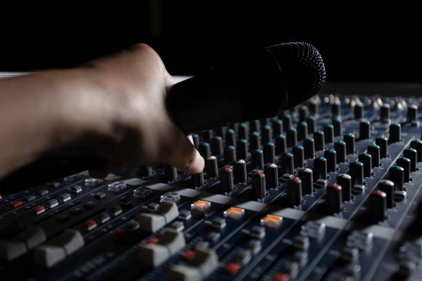 istock Men's hands are controlling the console of a large hi-fi system. Sound equipment. Control panel of a digital studio close-up mixer. 1776345995