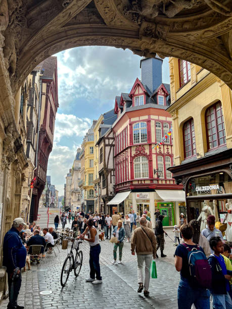 Under the arch of the Gros-Horloge in Rouen Rouen, France - July 1, 2023: The Gros-Horloge is a 14th century astronomical clock in Rouen, Normandy. The clock is installed in a Renaissance arch crossing the Rue du Gros-Horloge. The mechanism is one of the oldest in France, the movement having been made in 1389. rue du gros horloge photos stock pictures, royalty-free photos & images