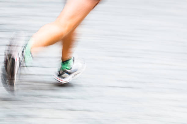 istock Motion blurred runner's feet in a city 177634800