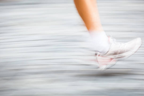 istock Motion blurred runner's feet in a city 177634801