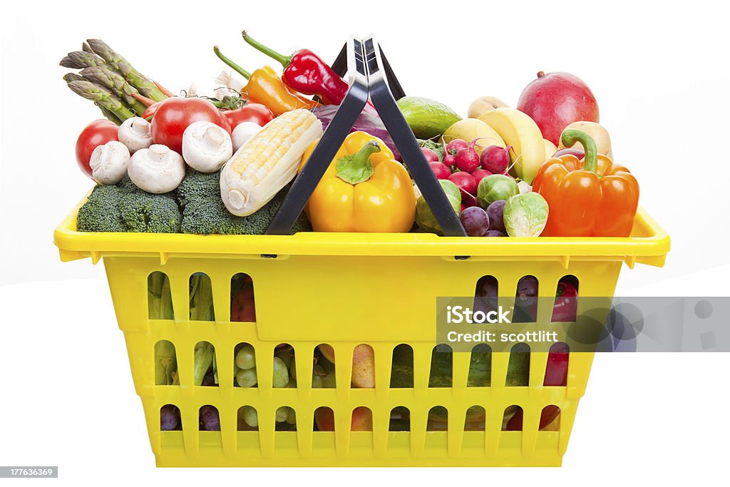 Shopping basket A yellow shopping basket full of fruits and vegetables isolated on white. Abundance Stock Photo