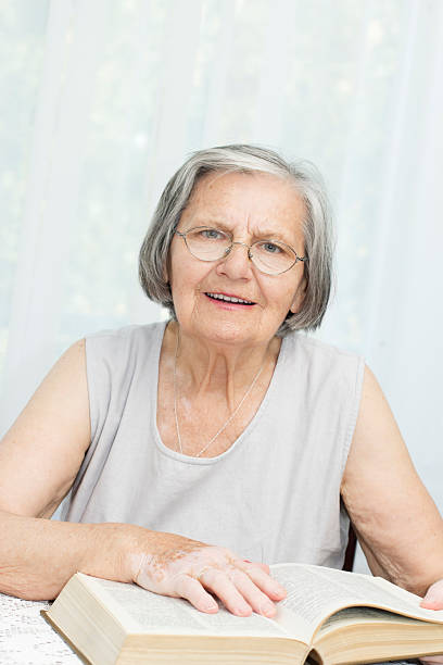 istock Senior woman with book 177636466