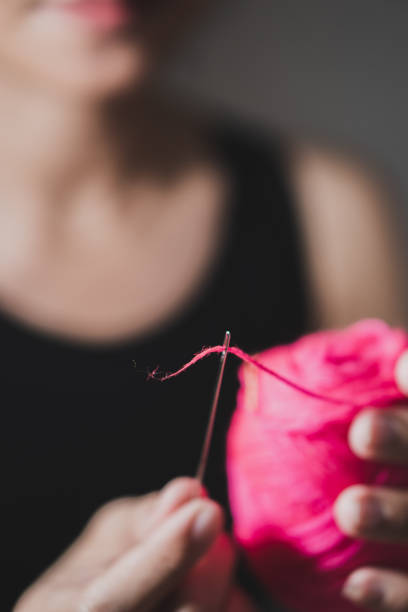 Close-up of hands knitting. Top view. Caucasian woman knitting sweater