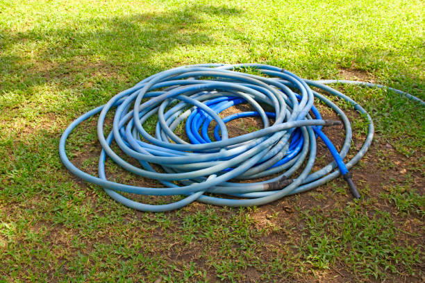 istock A blue irregularly coiled water hose lying on green grass 1776375180