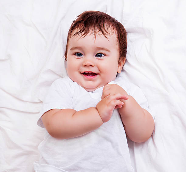 baby in bed stock photo
