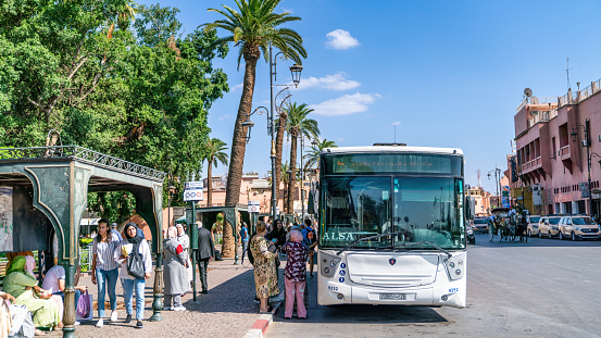 Marrakech, Morocco - 15 September 2022: Local Moroccan people getting on the public transportation bus in city center downtown