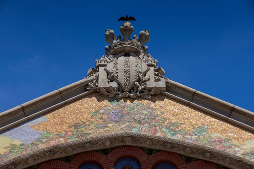 coat of arms of Valencia on the facade of Mercado de Colon in the Spanish city of Valencia; Valencia, Spain