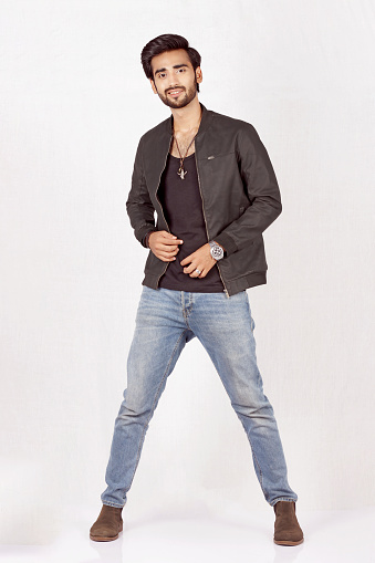 Pakistani Male Model posing in jacket and jeans with long boots