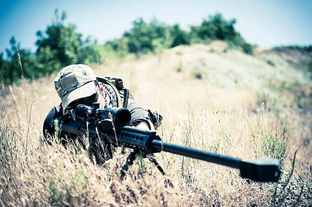 istock Sniper Aiming with Barrett M82A1 Precision Rifle in Arid Location 177646349