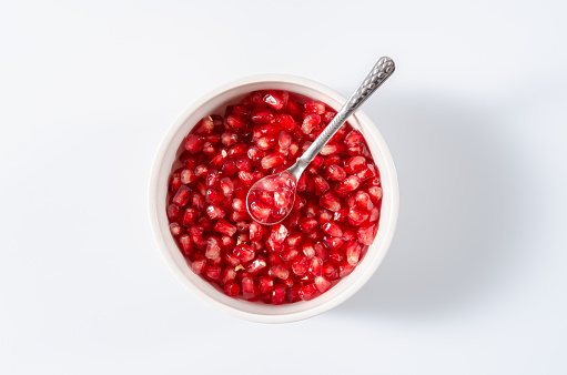 Fresh, cut pomegranate fruit, on a gray background, food concept, top view, no people,