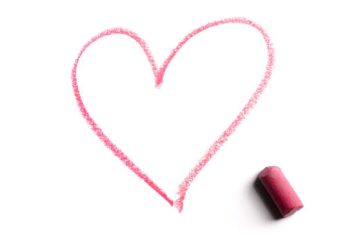 Pink valentine heart drawn in chalk isolated over white background.