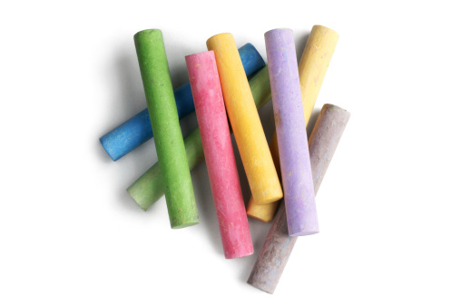 Multi coloured chalk isolated over white background.