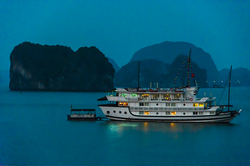 Tourist cruise boat sailing around islands at Halong Bay, Vietnam