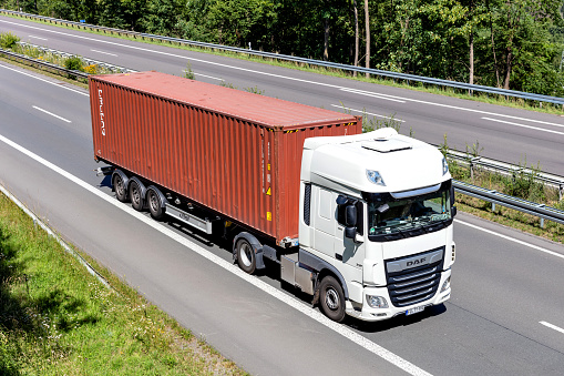 Wiehl, Germany - June 26, 2020: DAF XF truck with Triton container on motorway