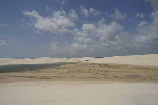 Lençóis Maranhenses National Park (Parque Nacional dos Lençóis Maranhenses[a]) is a national park in Maranhão state in northeastern Brazil, just east of the Baía de São José. Protected on June 2, 1981, the 155,000 ha (380,000-acre) park includes 70 km (43 mi) of coastline, and an interior composed of rolling sand dunes. During the rainy season, the valleys among the dunes fill with freshwater lagoons, prevented from draining due to the impermeable rock beneath. The park is home to a range of species, including four listed as endangered, and has become a popular destination for ecotourists