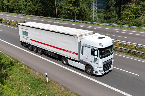 Wiehl, Germany - June 25, 2020: European Transport DAF XF truck with curtainside trailer on motorway