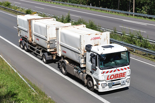 Wiehl, Germany - June 25, 2020: Lobbe Mercedes-Benz Actros roll-off container truck on motorway