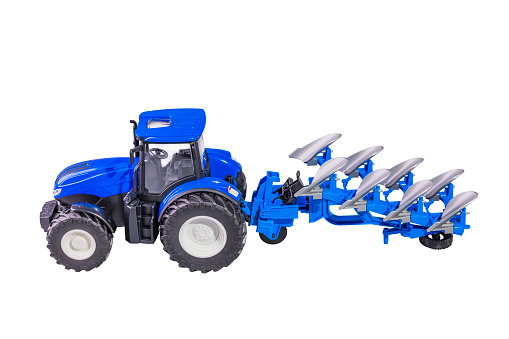 Isolated view of radio-controlled toy farm tractor model with plow on white background.