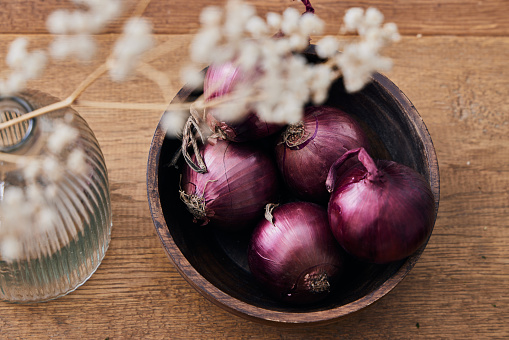 A pile of onions at the vegetable market.