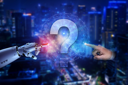 A conceptual image showcasing the merging of advanced robotics and human interaction against an urban skyline. A robotic arm and a human hand point towards a glowing holographic question mark, symbolizing the future of technology, questions, and potential challenges.