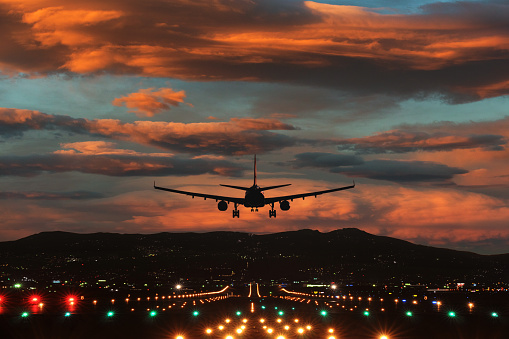 Fighter Jet flying over the clouds at sunset