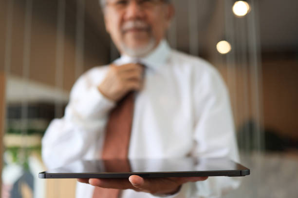 Senior business man hold tablet on horizontal , copy space for multi-purpose
