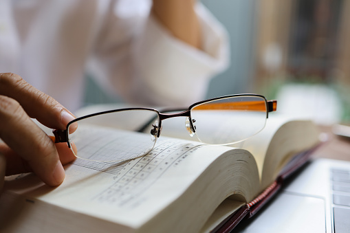 Close-up eyeglasses on a book, the work lifestyle of an elder man