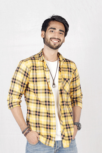 Pakistani Male Model posing in yellow shirt and blue jeans