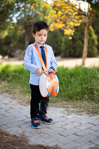 boy playing trumpet in the park