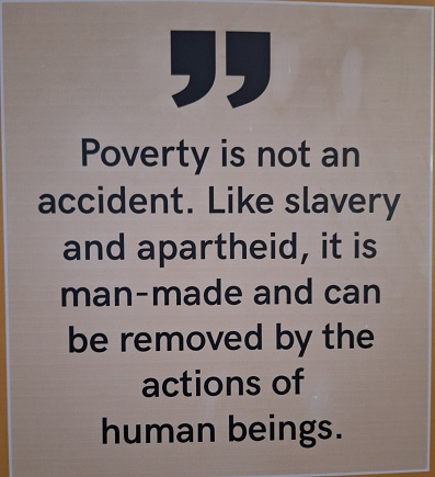 A printed quote by Nelson Mandela about poverty