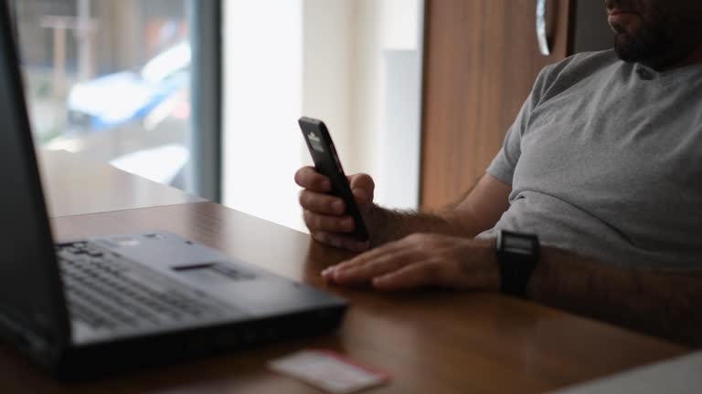 Young businessman spending time with his phone