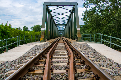 Railroad bridge over the Tisza river near Algyo in Hungary. The writing: crossing the bridge is prohibited and dangerous