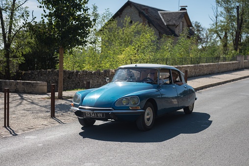 Rocamadour, France – October 13, 2023: A beautiful classic blue Citroen DS with a white roof driving through a French town