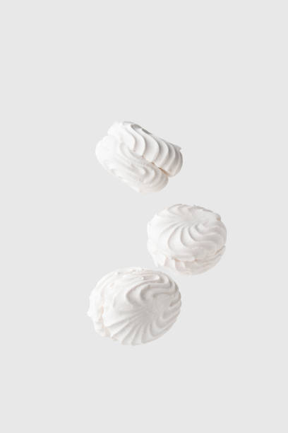 istock Three soaring white zephyr marshmallow on white background. flying food levitation 1776657296