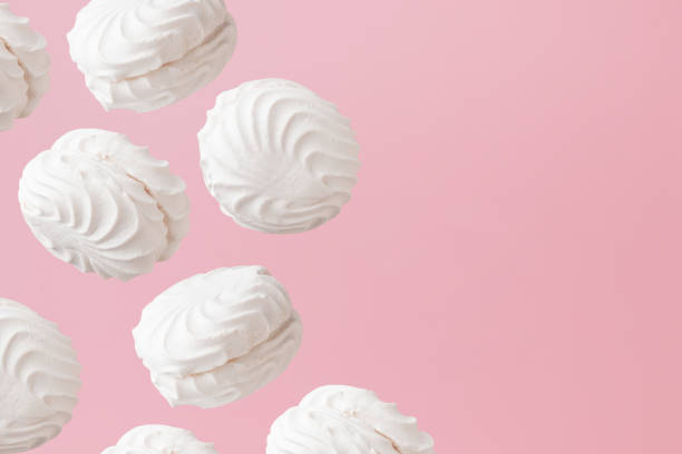 istock White zephyr marshmallows on light pastel pink background banner with an empty space 1776658479