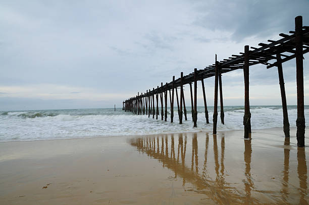 istock Long Wooden Bridge on the beach with reflection 177669644